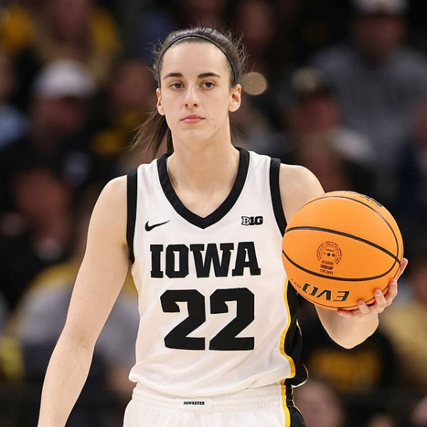 Caitlin Clark in action during her WNBA debut, scoring a basket for the Indiana Fever.