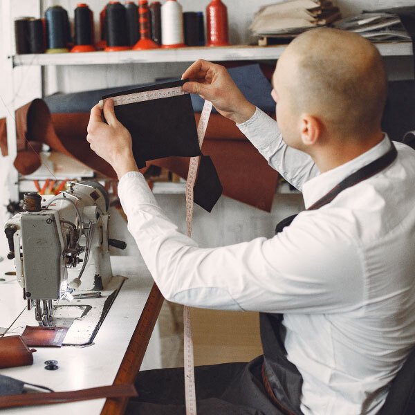 man creates leather ware